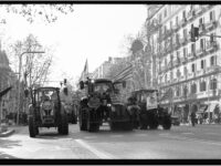 Tractors and people protesting on a bustling city street in vintage black and white style.